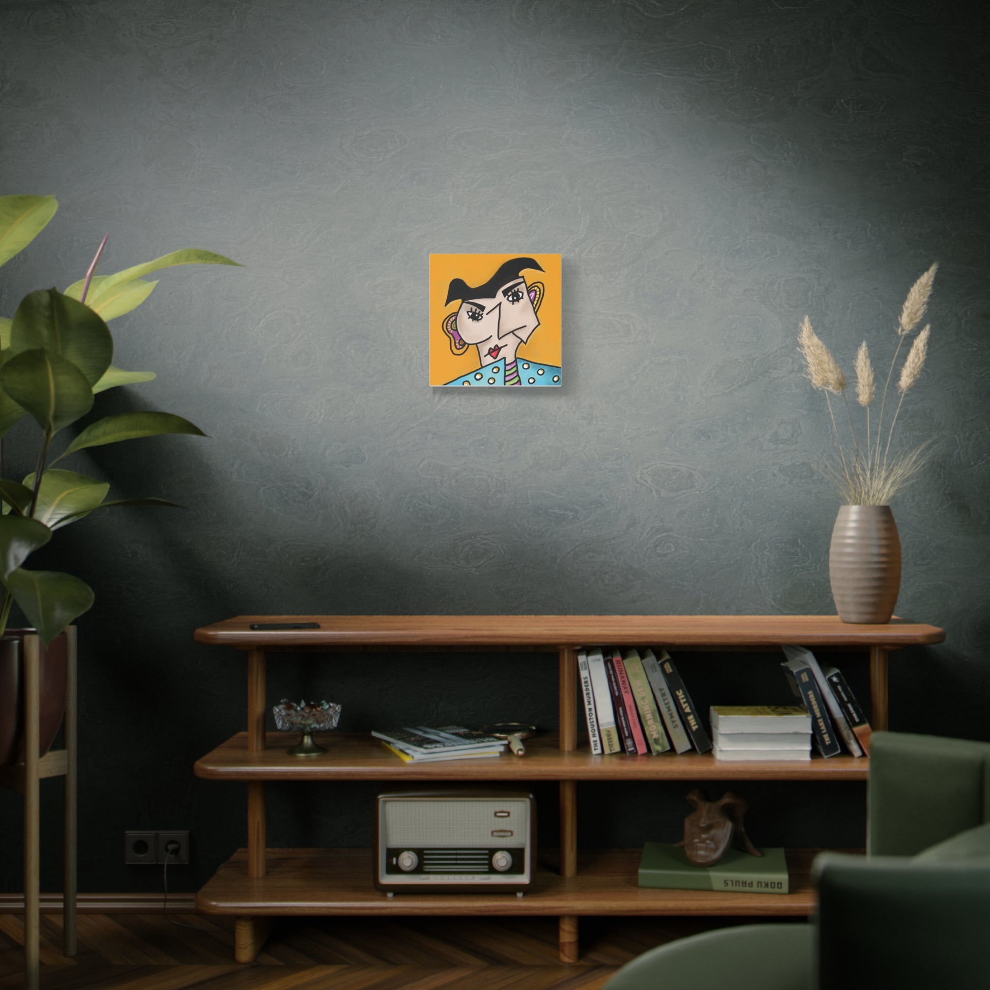 Room interior with a shelf, books, a plant, and a wall art piece.