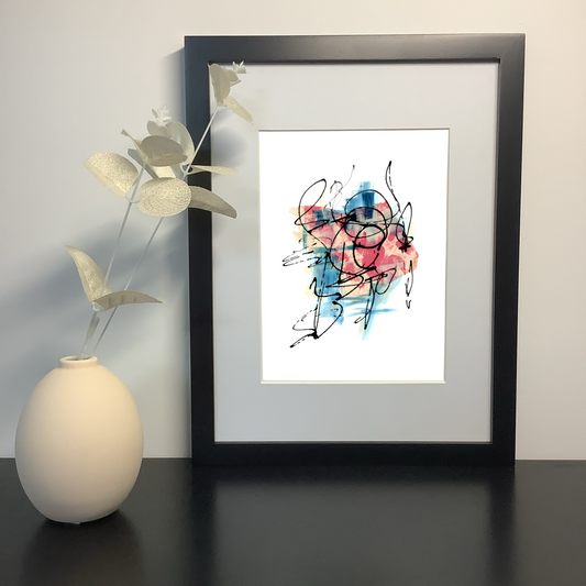 Energetic mixed media artwork by artist Julia Hargreaves showcased in a black frame on a shelf next to a ceramic vase and foliage.
