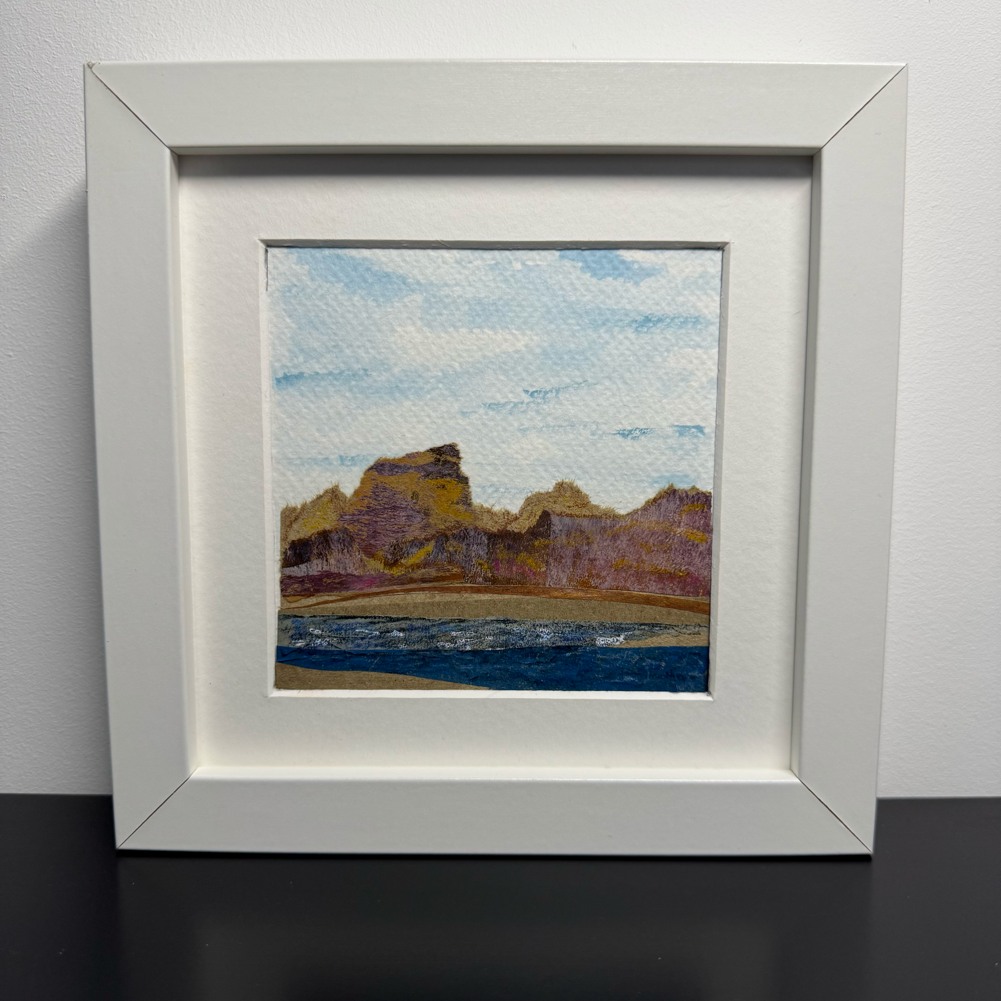 Landscape artwork in a white frame