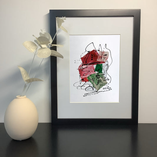 Photograph featuring a framed artwork with a  ceramic vase and foliage.  The artwork, by Julia Hargraeves features a dynamic abstract design with black, red, and green tones.  The piece includes collage and freeform elements, giving it a lively and expressive feel.