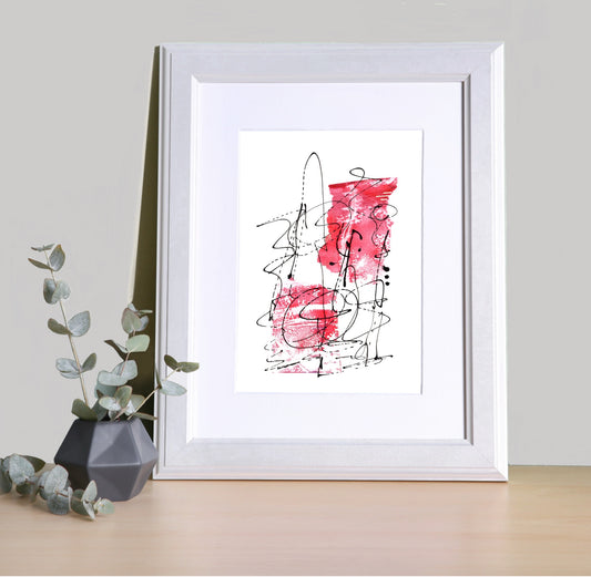 Image featuring a framed abstract artwork on a shelf with a black vase and foliage.  The artwork is abstract in design with red tones and black dynamic line, which give it a lively and expressive vibe.